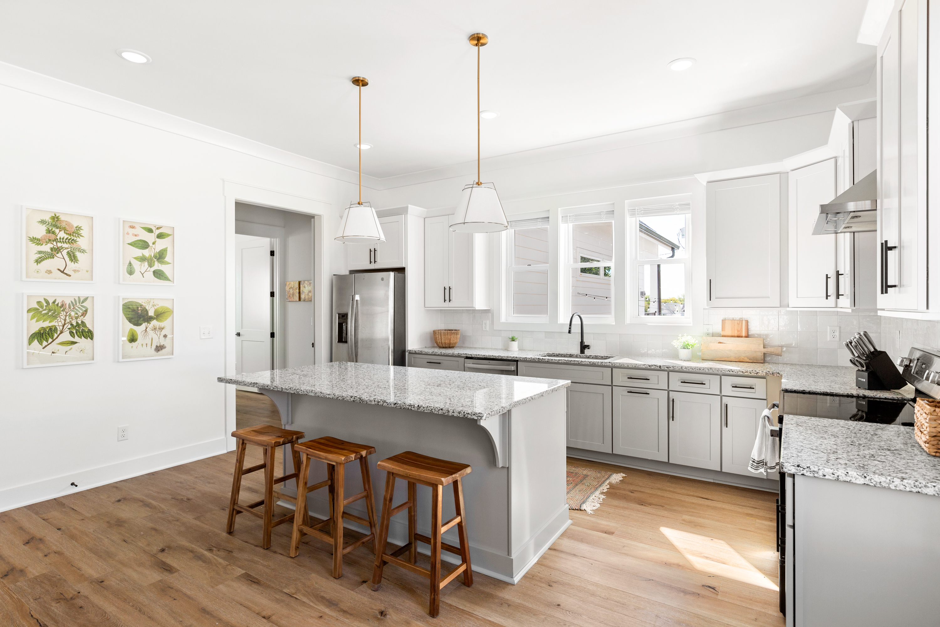 Spacious kitchen with large island, stainless steel appliances, and elegant decor
